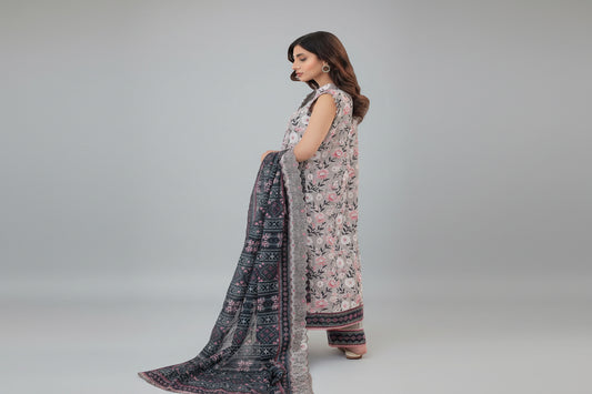 Woman wearing a floral dress with a matching dupatta on a white background