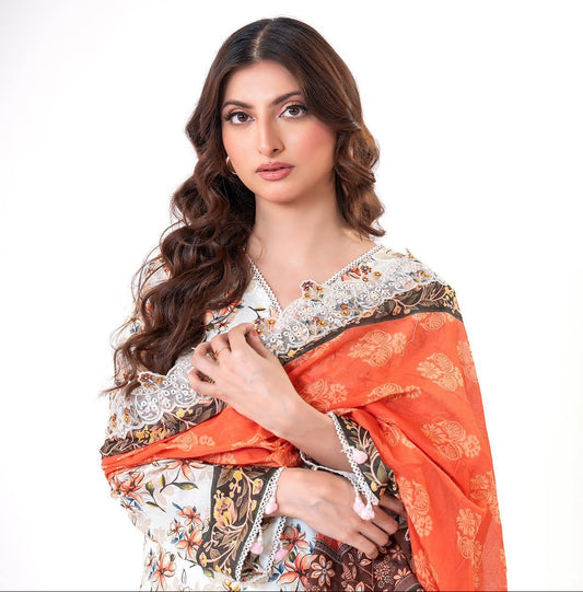 Woman wearing a traditional outfit with an orange and floral patterned dupatta.