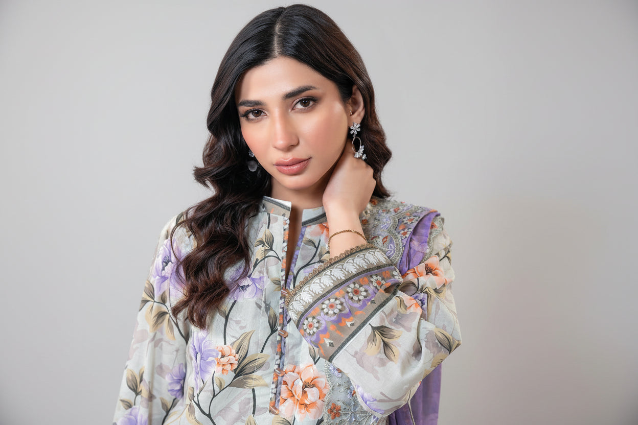 Woman wearing a floral embroidered outfit with a white background