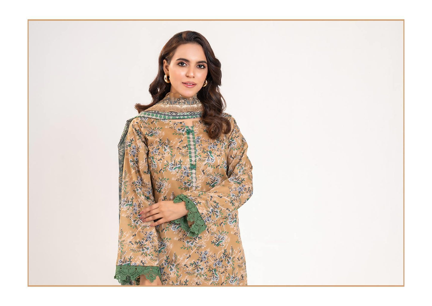 Woman wearing a patterned dress with green accents on a white background