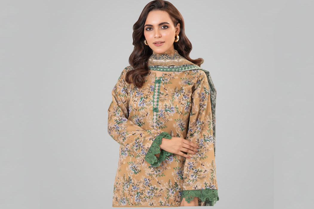 Woman wearing a patterned dress with green accents on a white background