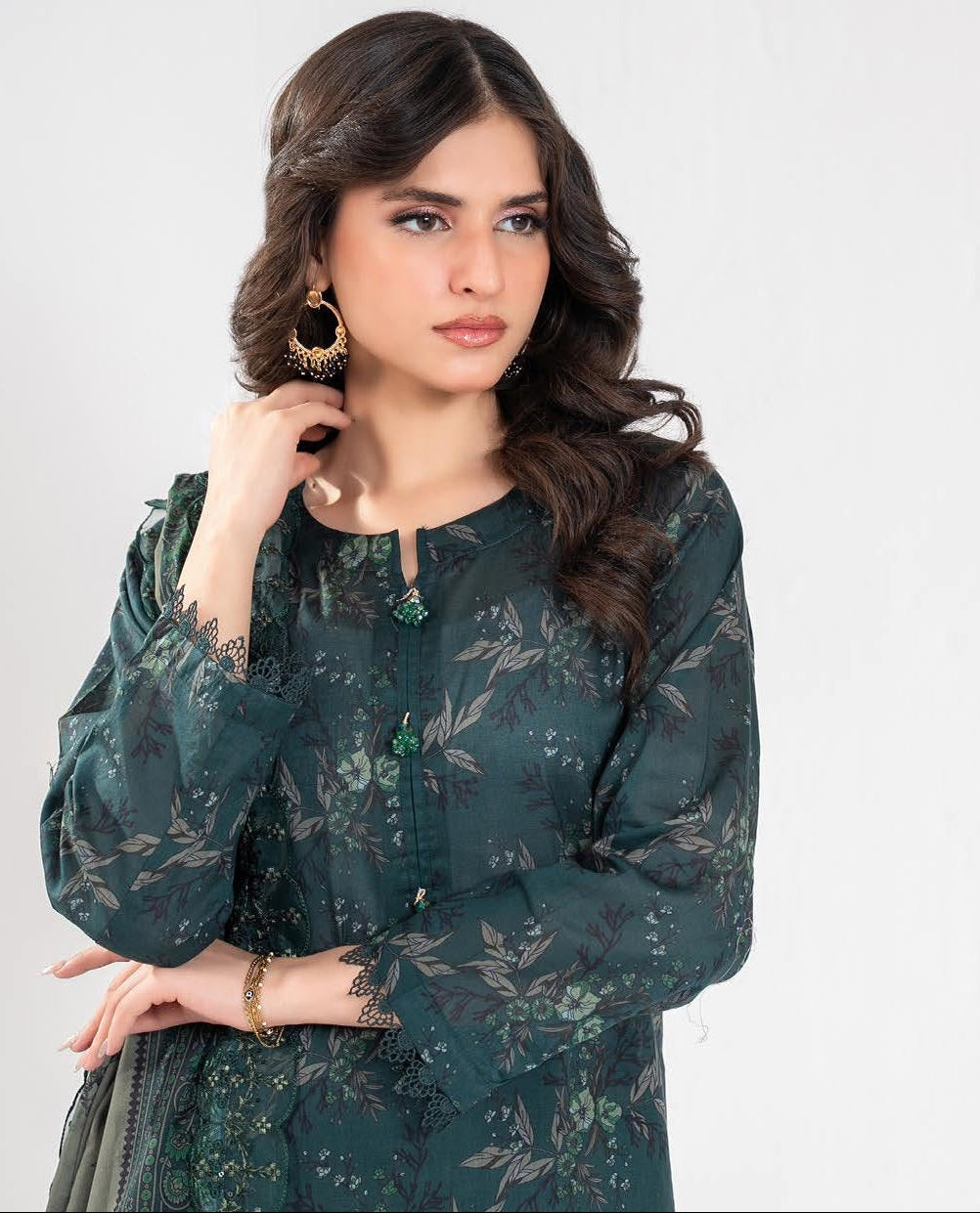 Woman wearing a green traditional outfit with multiple poses displayed.