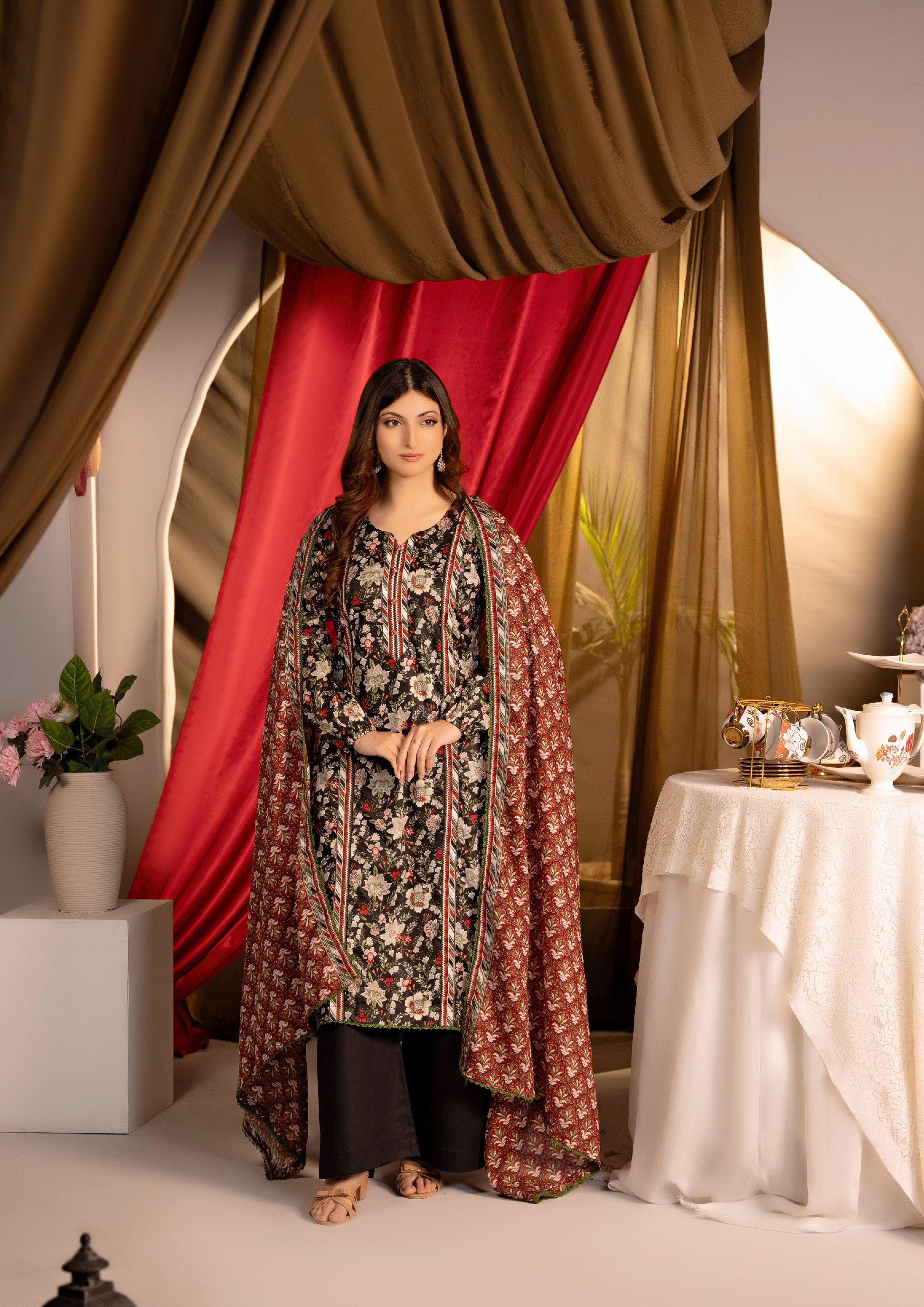 Mannequin wearing a floral dress with a red curtain background