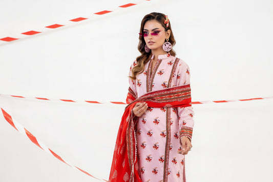 Woman in a pink and red traditional outfit with sunglasses and jewelry on a white background