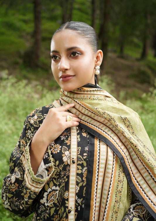 Woman wearing a patterned scarf outdoors with greenery in the background